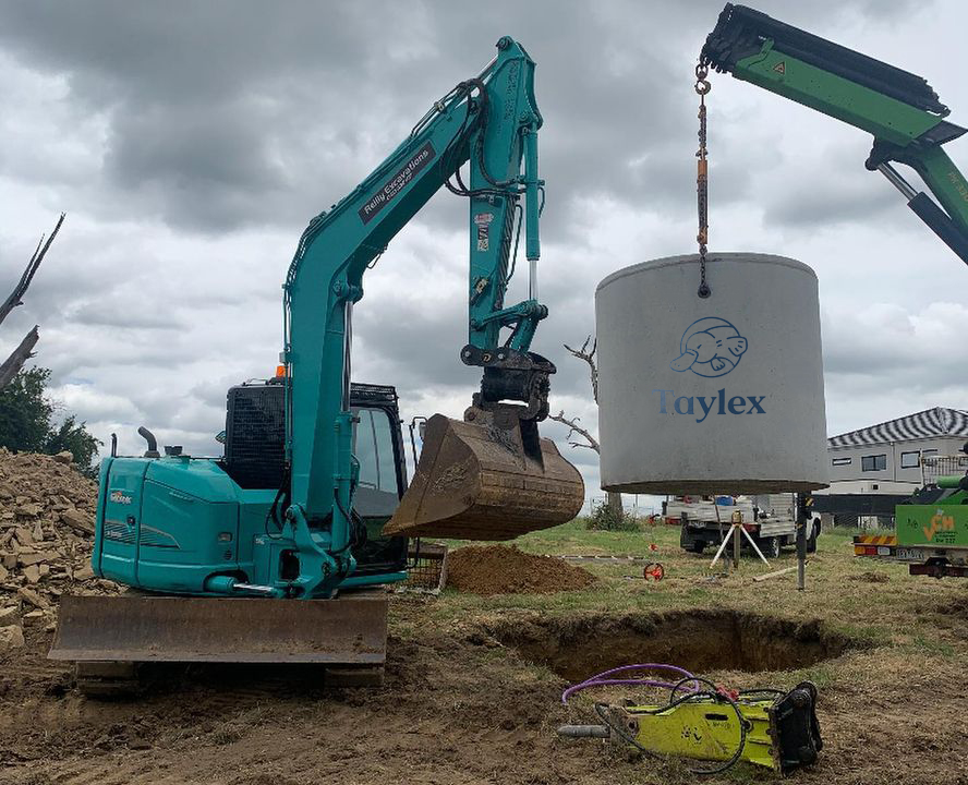 A Taylex tank is lowered into the ground to be installed
