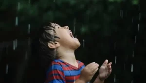 A child drinking rainwater