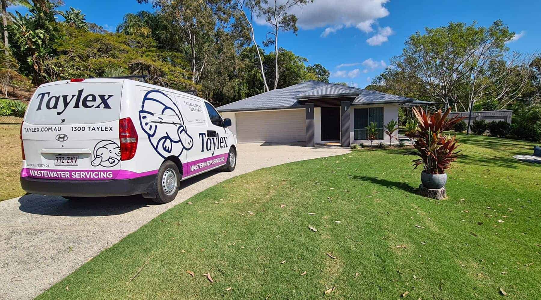 A Taylex servicing van parked outside a house