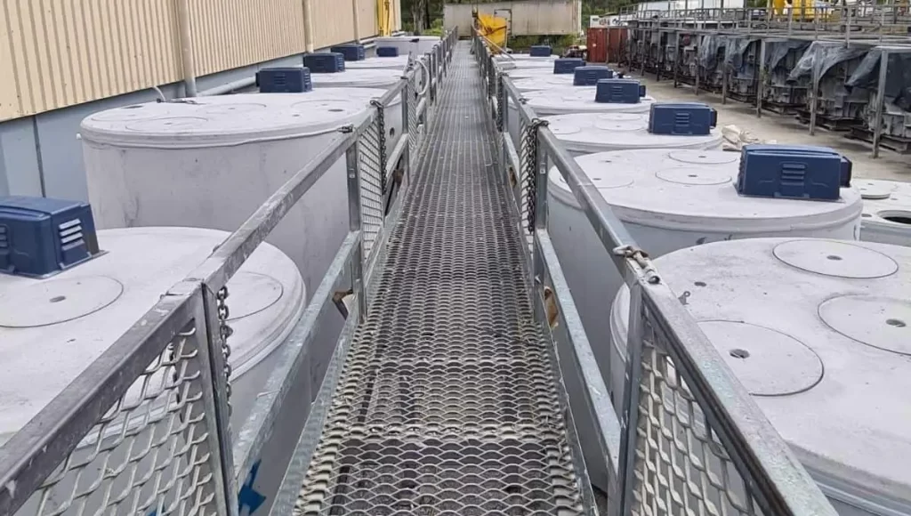 Walkway between multiple septic tanks at a facility